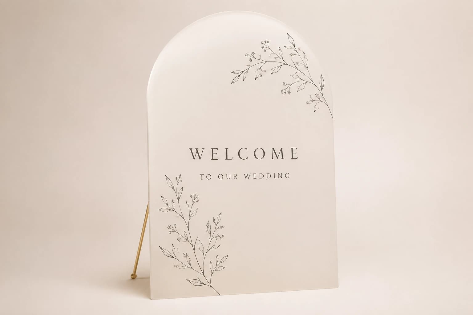 Arched ivory acrylic wedding welcome sign with delicate botanical corners.